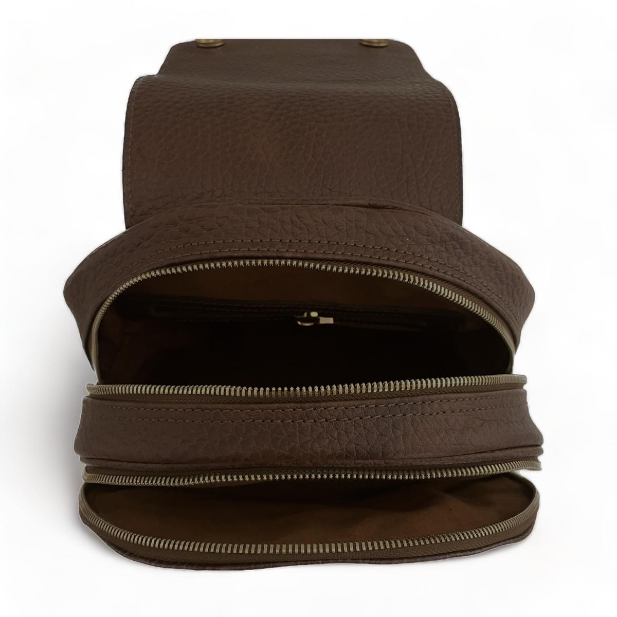 Brown leather backpack — angled view with top handle and zipper closure