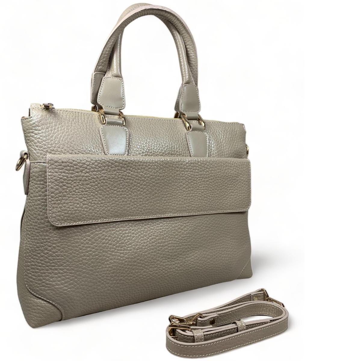 Close-up view of cream leather laptop bag showing the front lock pocket and premium leather texture