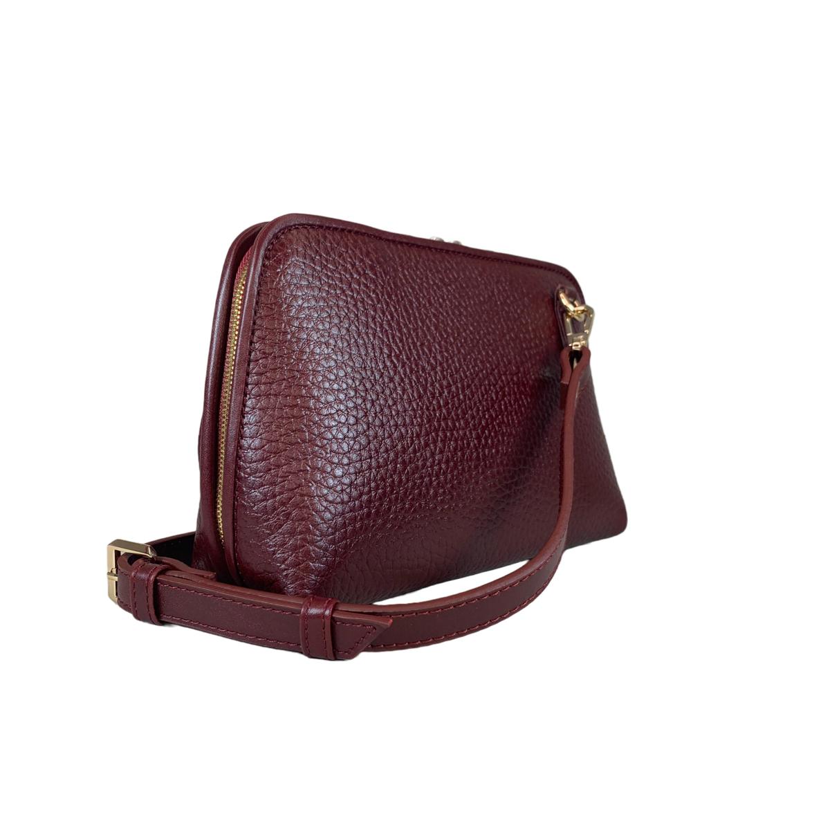 Adjustable shoulder strap detail on dark red leather bag