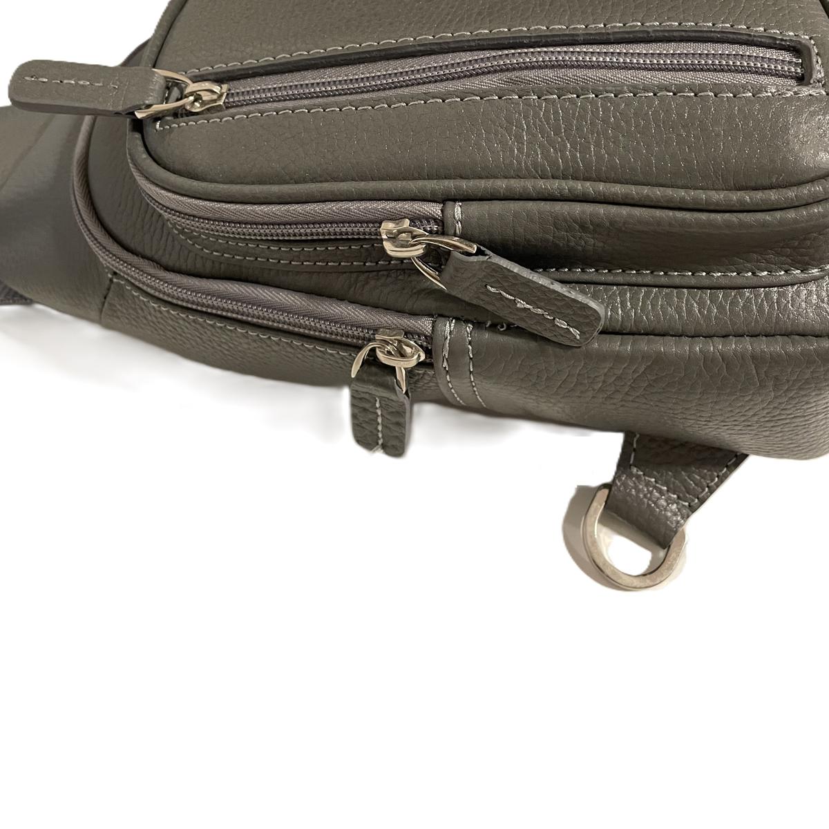 Three zippered compartments detail of LeatherLuxe grey sling bag with internal organization features