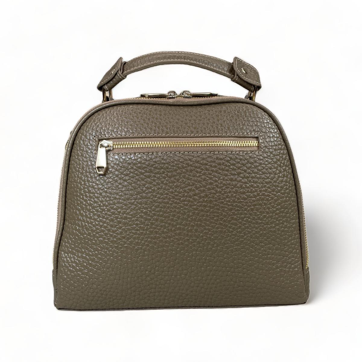 Back view of beige leather satchel showing exterior zip pocket and quality stitching