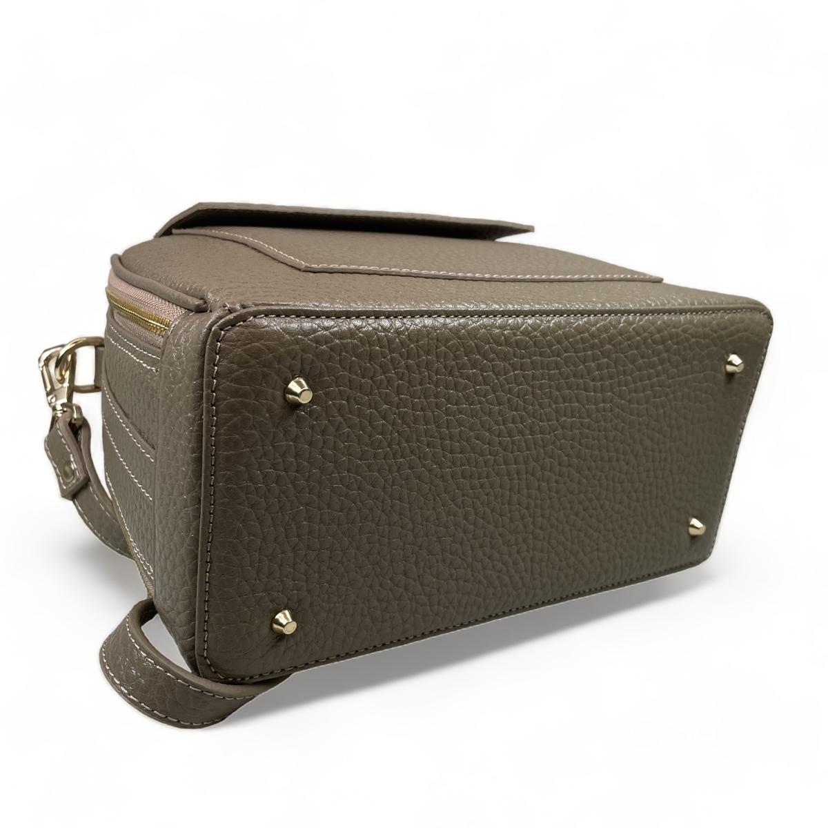 Beige leather satchel handbag detail showing premium craftsmanship and versatile design