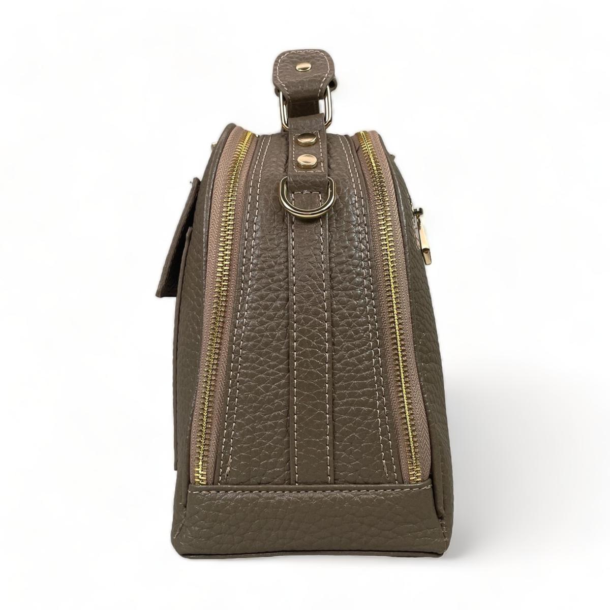 Side profile showing trapezoid shape and base studs, beige satchel