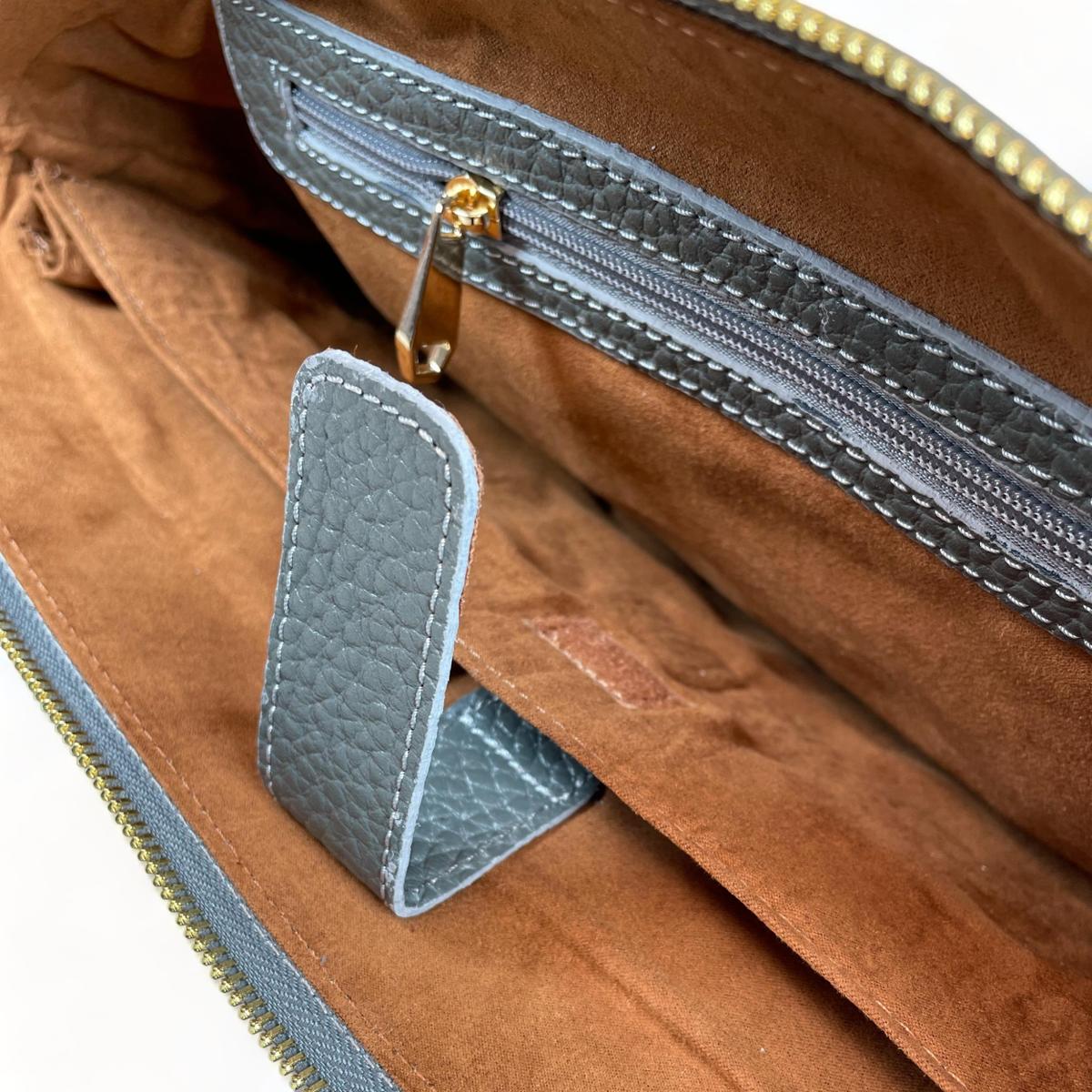 Gray leather bag corner detail showing craftsmanship and stitching quality
