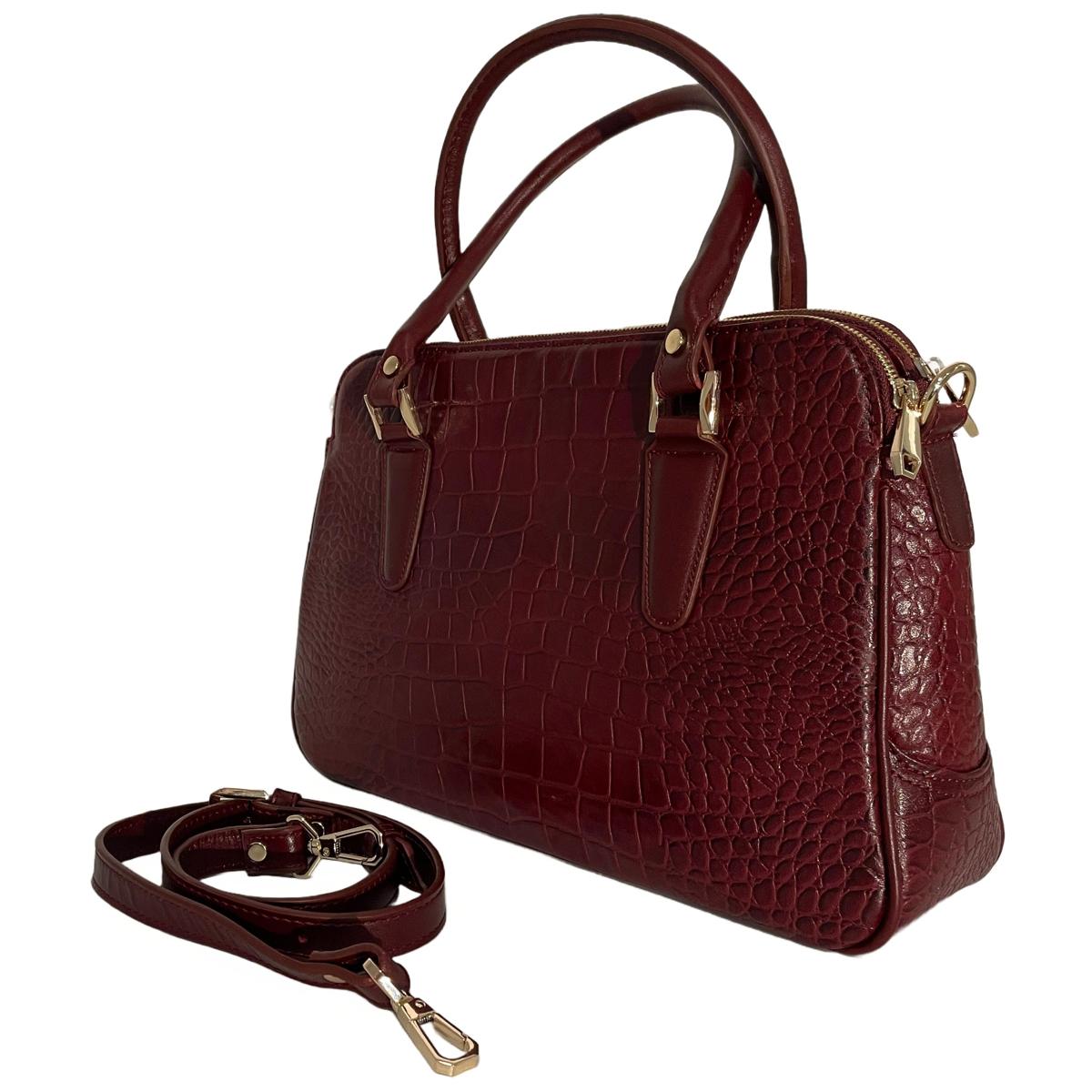 Close-up detail of red leather office bag showing texture and craftsmanship