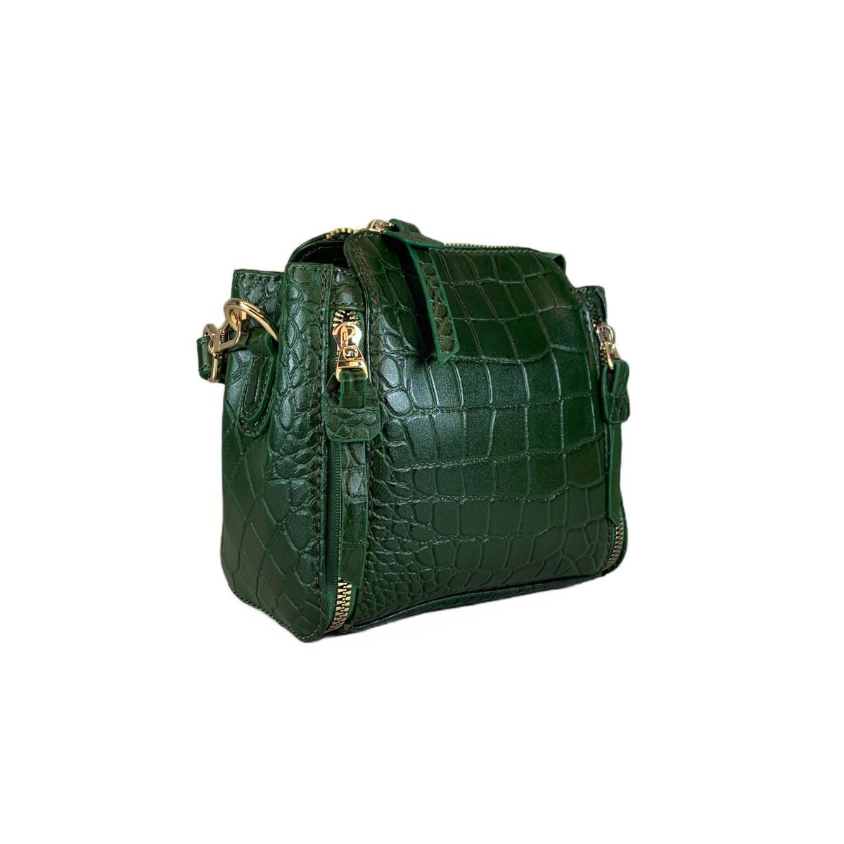 Three-quarter rear view of emerald crocodile-embossed leather mini handbag showing structured pouch shape and decorative side zips
