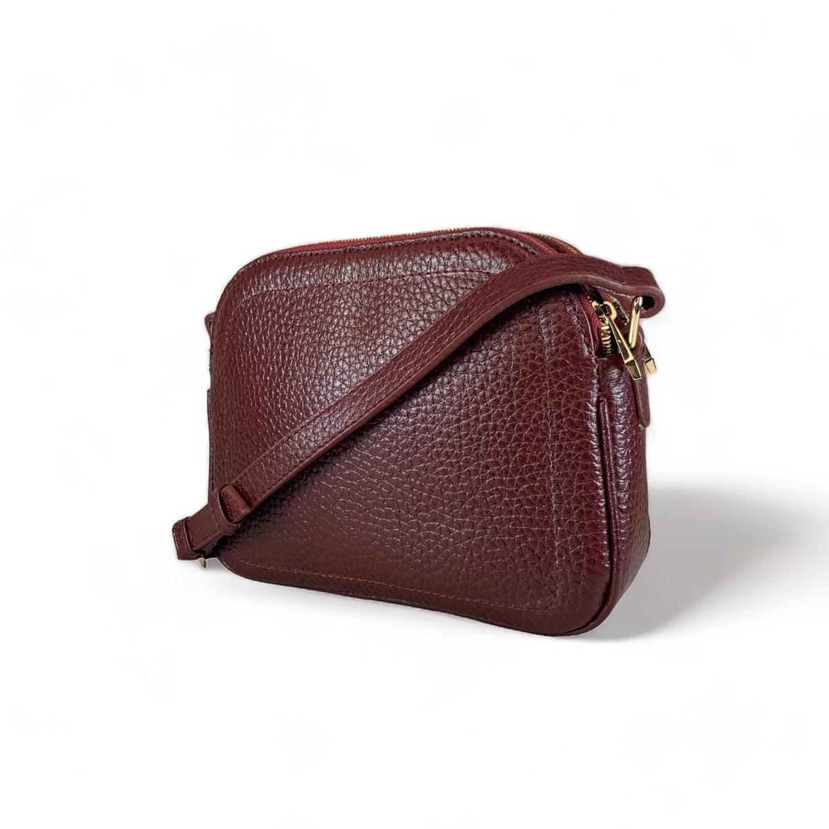 Side profile of dark red leather satchel, compact dimensions 24 × 20 × 7 cm