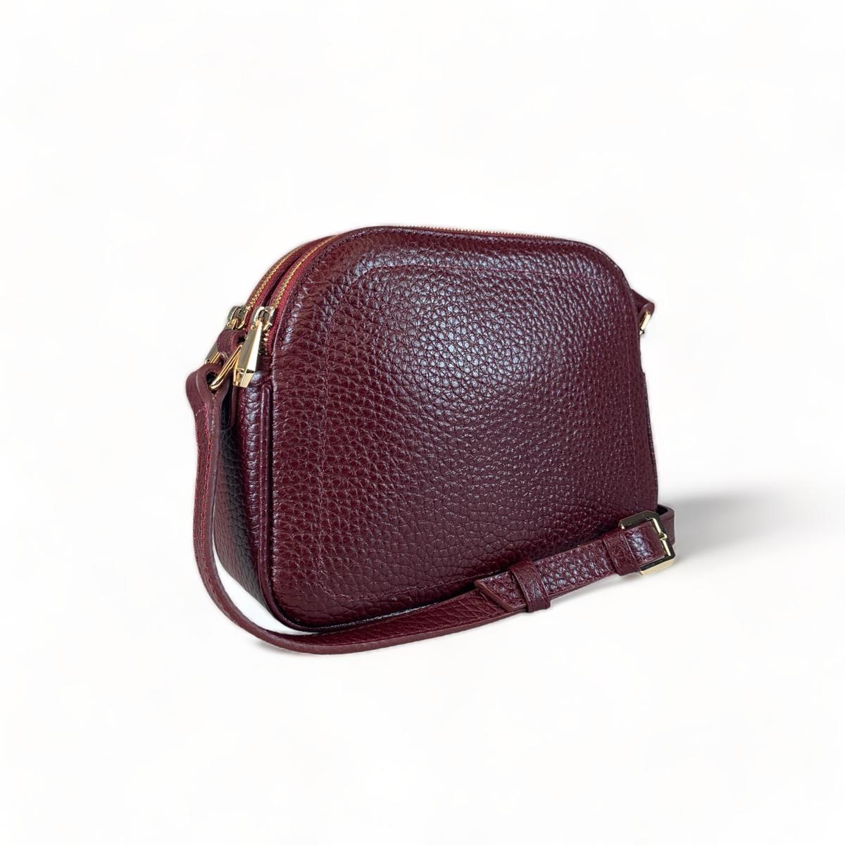 Back view of red leather shoulder bag showing clean panel and strap attachments