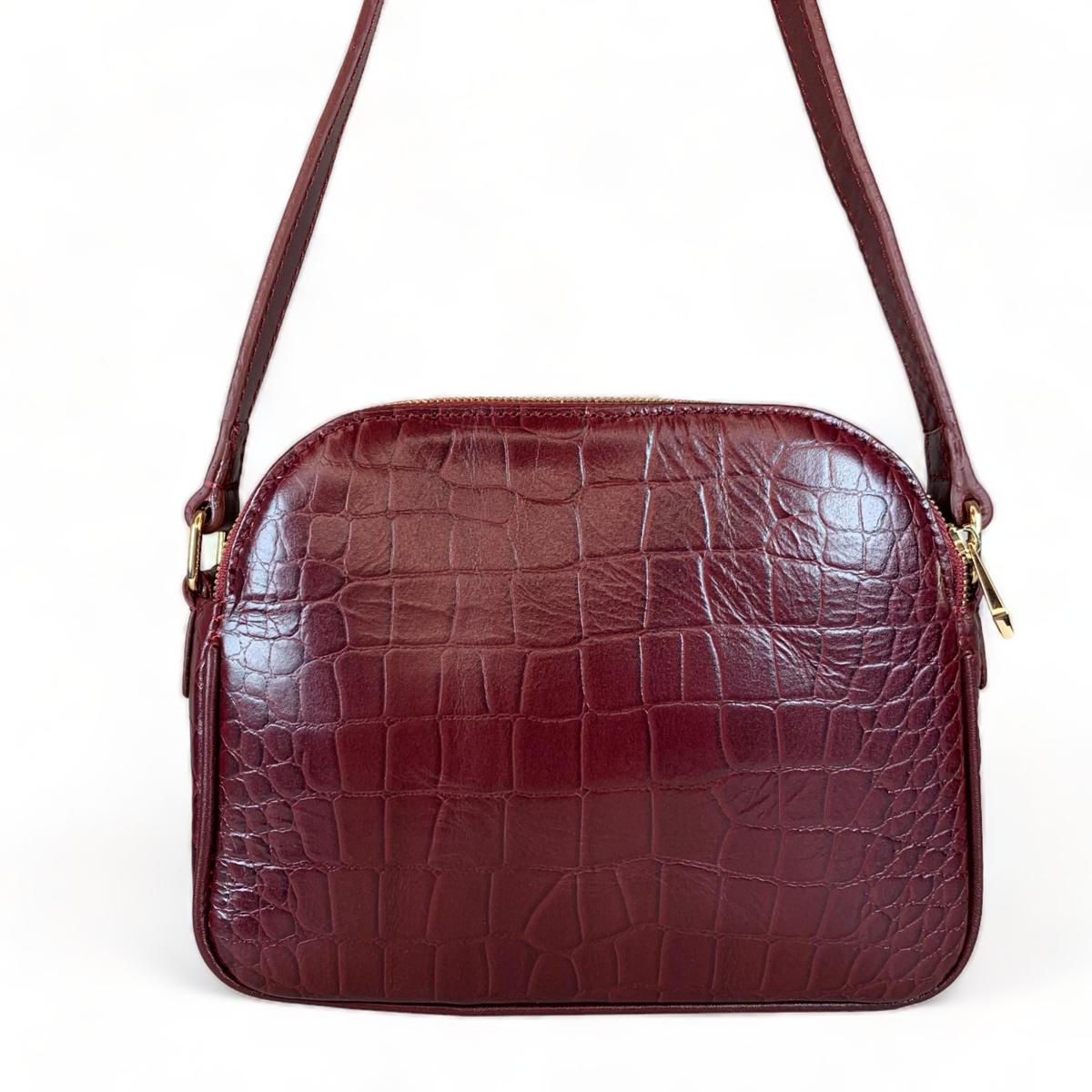 Side profile of dark red leather bag, compact 24×20×7 cm design
