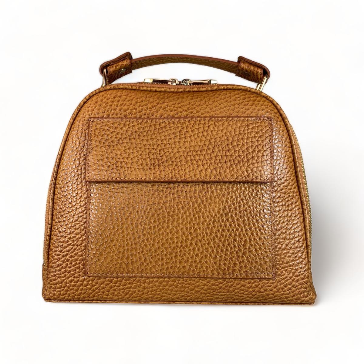 Leather handbag styled flat lay showing bag structure and design details