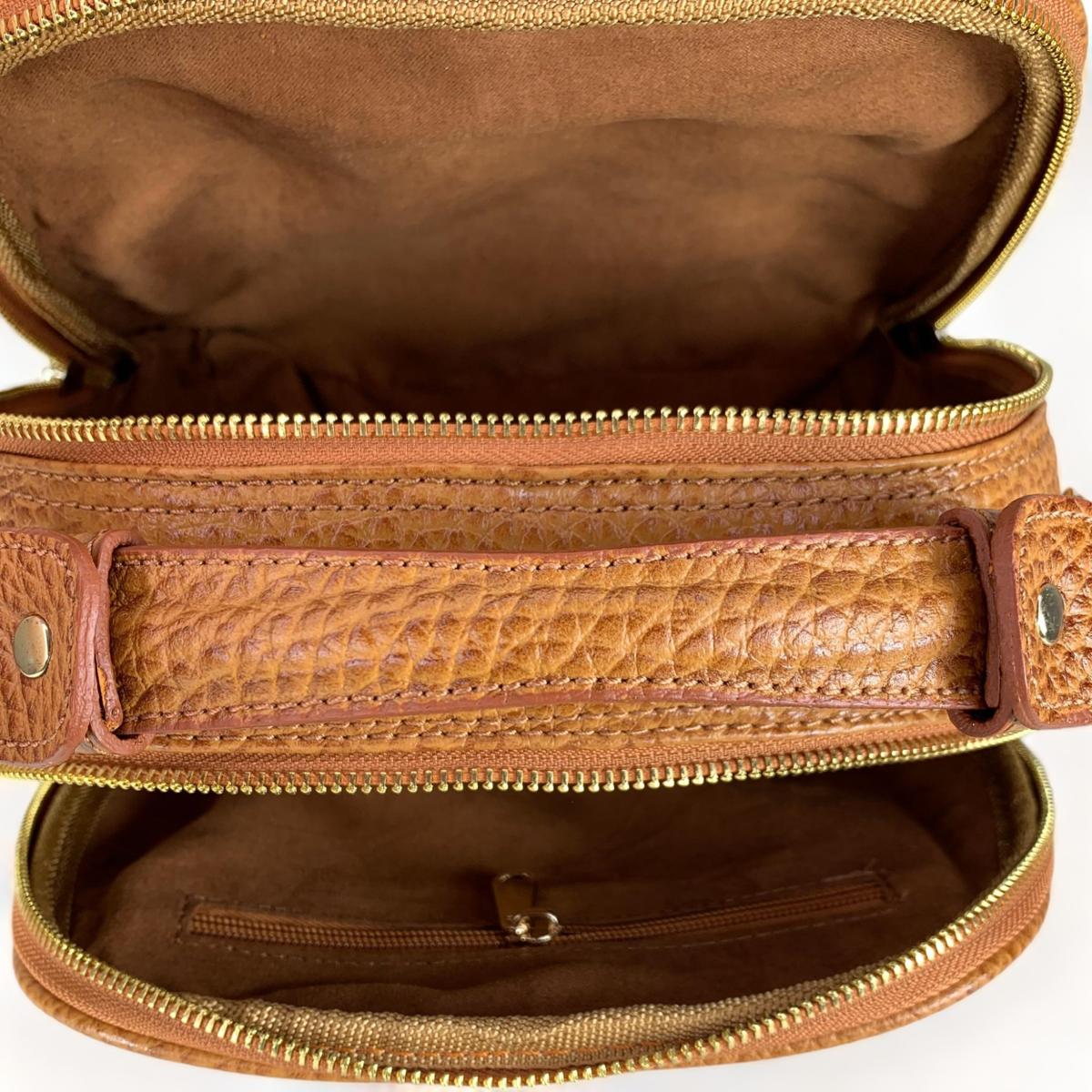 Leather handbag interior view displaying multiple compartments and zip pockets
