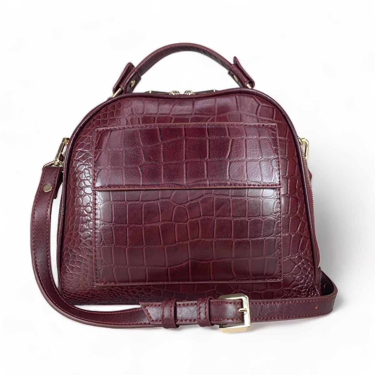 Red leather women's handbag styled as shoulder bag with adjustable strap