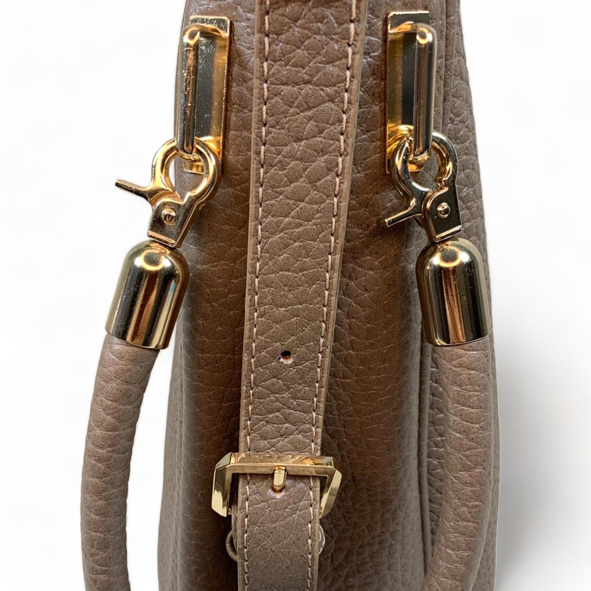 Detail shot of khaki leather tote bag - highlighting premium top-grain leather texture and hardware