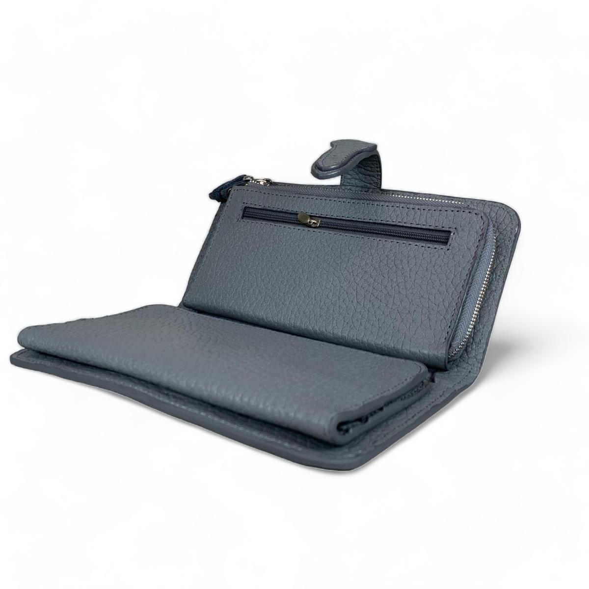 Side and back angle of gray leather clutch highlighting slim profile and reinforced frame.