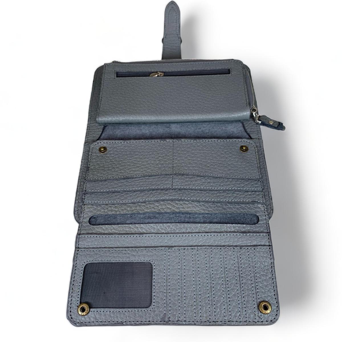 Gray leather clutch capacity demo — separate phone compartment fits iPhone Pro Max size.