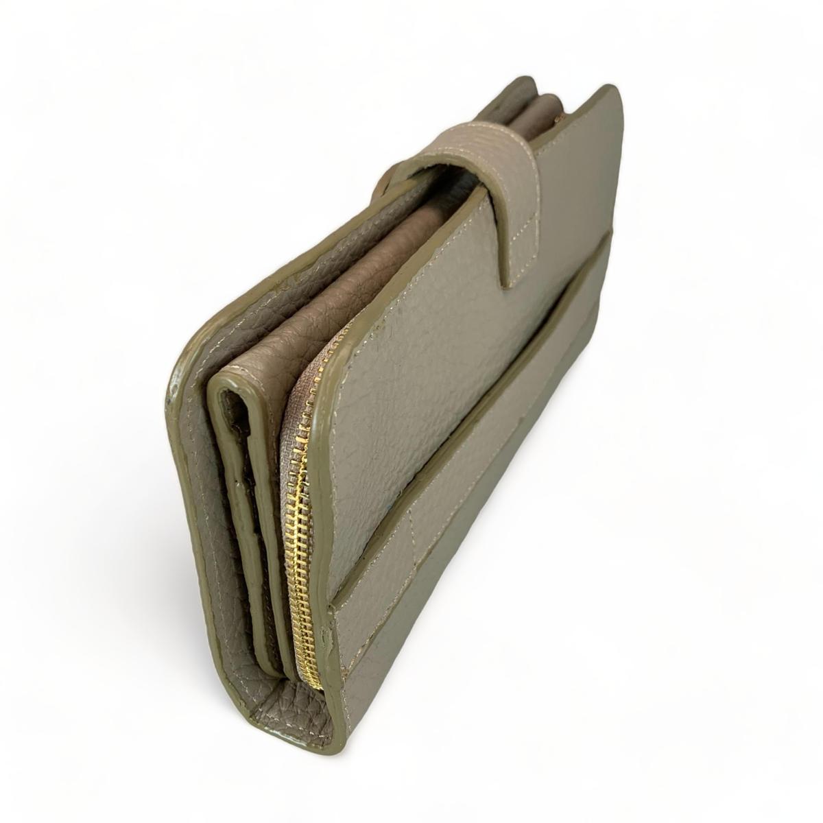 Cream leather clutch — angled product shot showing smooth grain and zip