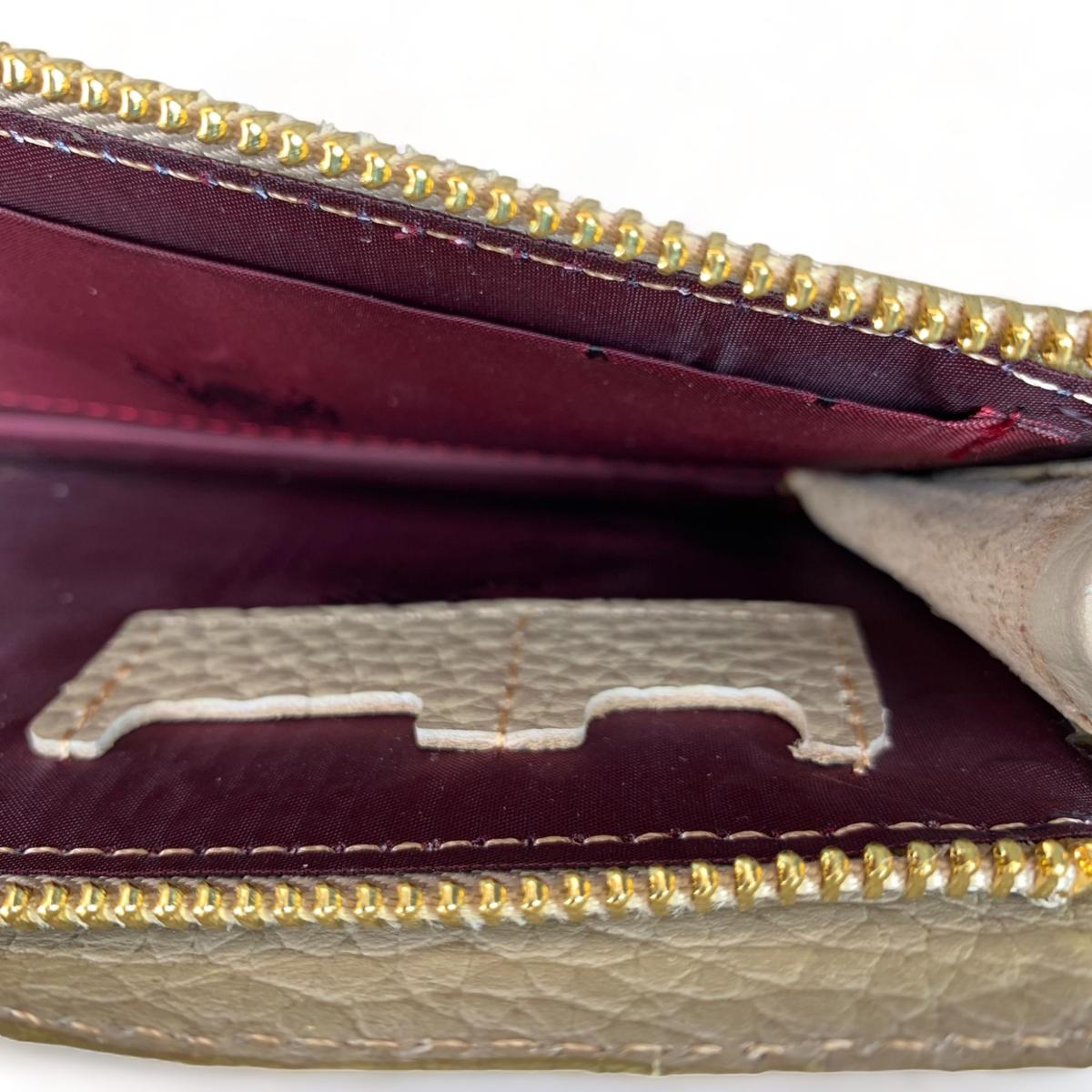 Cream leather clutch — back side with zipper detail