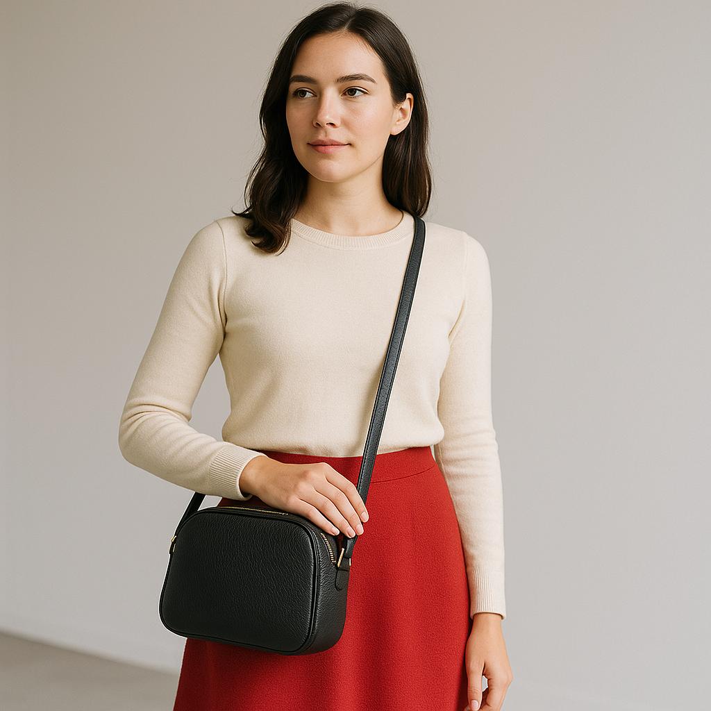 Black leather crossbody bag side view - compact 3-compartment shoulder bag with adjustable strap