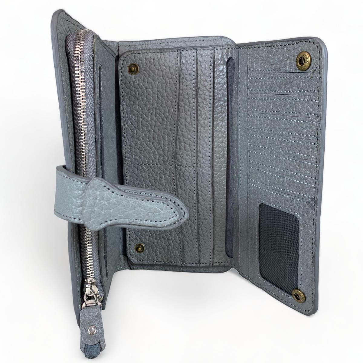 Interior of gray leather clutch showing 10 card slots, ID window, 2 zip and 3 slip pockets.