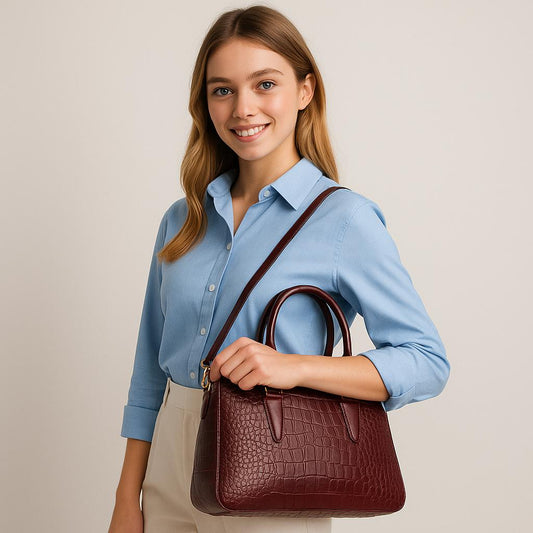 Woman holding a brown handbag against a plain background