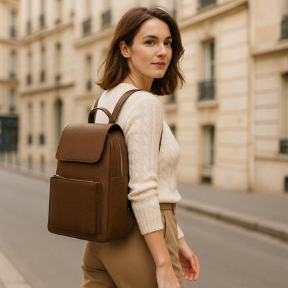 Lifestyle: woman wearing brown leather backpack walking on city street