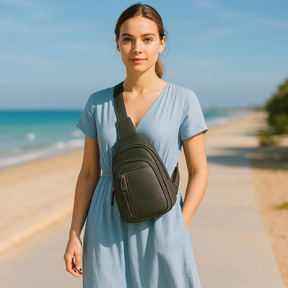 Woman wearing grey leather sling bag crossbody style on beach - LeatherLuxe unisex design